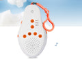 White noise device with orange accents on a blue sky background